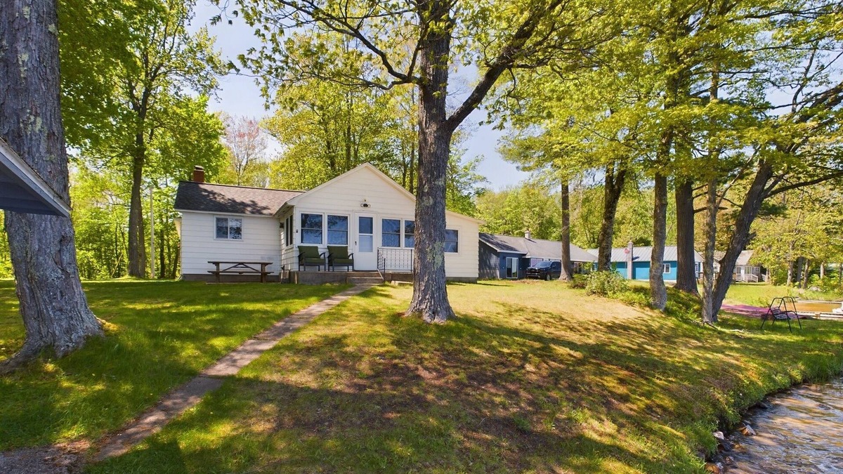 Munising Cabin | 16 Mile Lake Getaway-Lakefront with Water Toys & Family Time Around a Fire