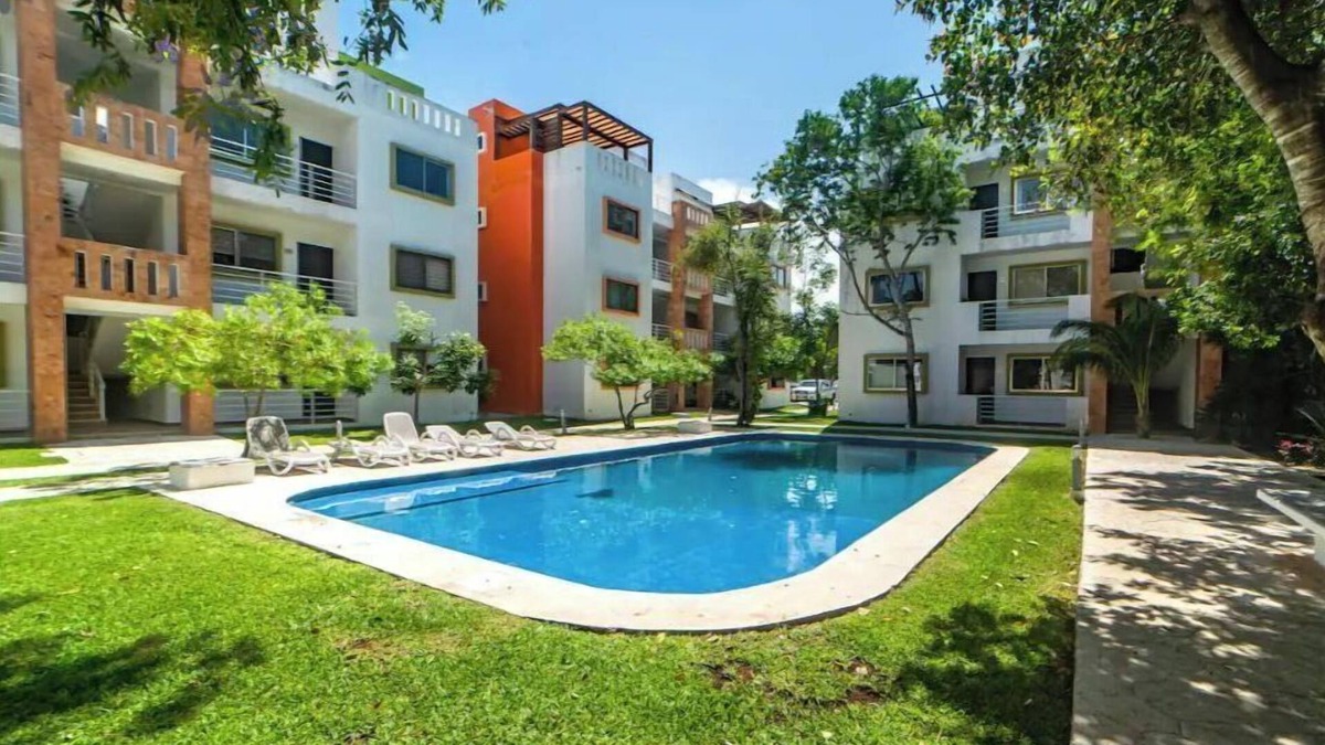 Alfredo V. Bonfil Apartment | Airport condo w/KING BED pool, security, kids game park + bbq area with lounge!