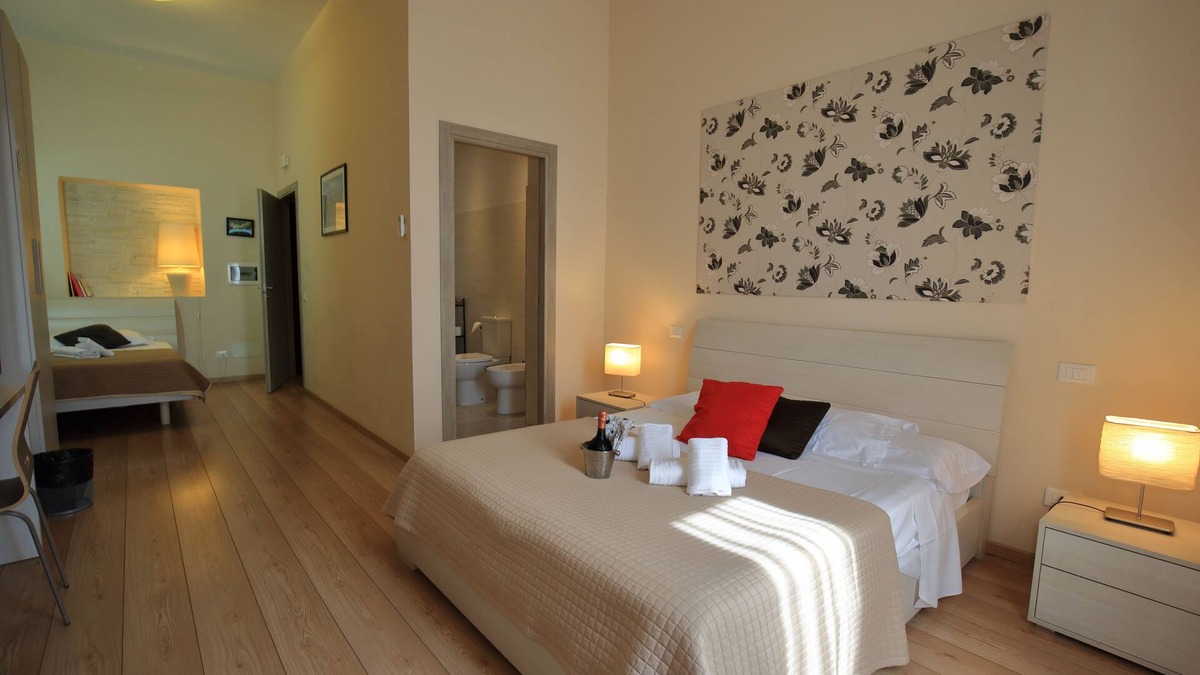 Esquilino Bed & Breakfast | Aria Rome Rooms triple room with balcony view of Basilica di San Giovanni
