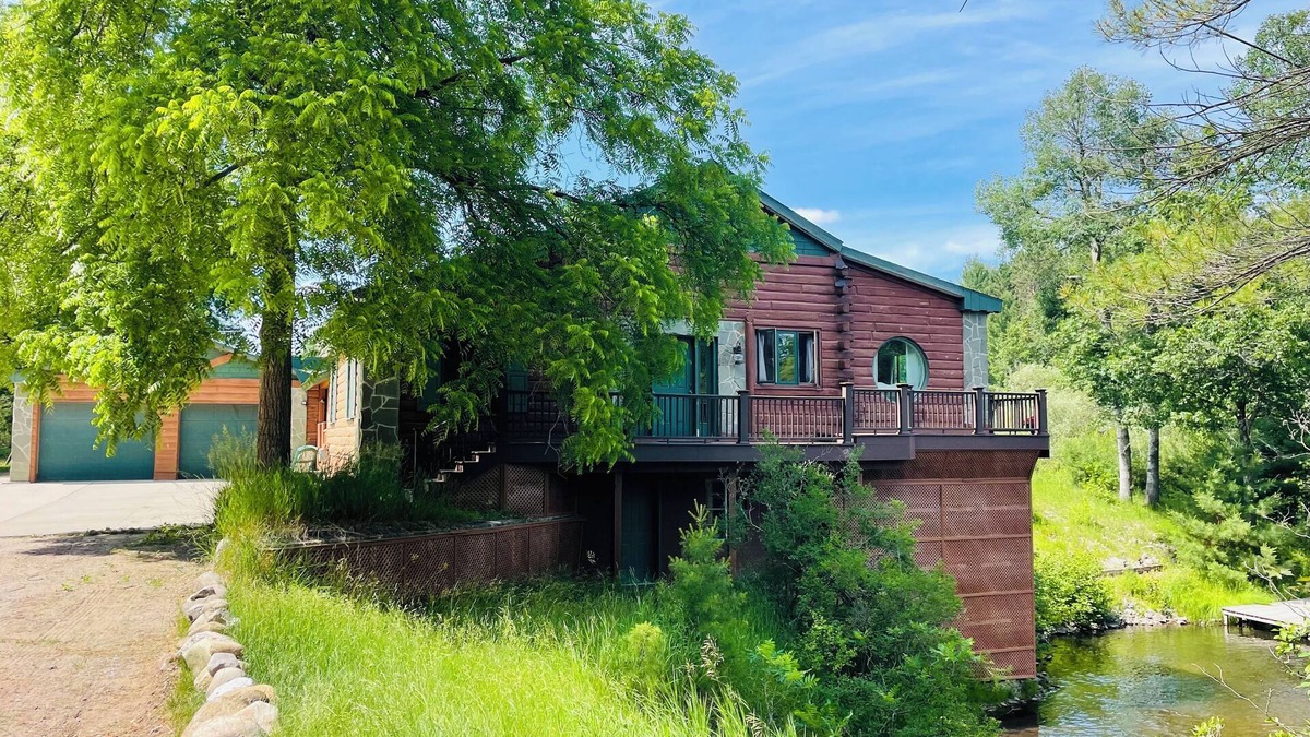 Grayling House | Ausable River waterfront 4-bed house in Grayling w/dock, patio, firepit, garage.