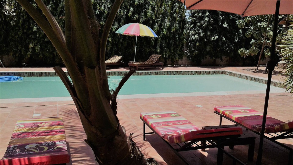 Serrekunda Bed & Breakfast | B & B Villa Calliandra, room with kingbed and ensuite bathroom with large pool.