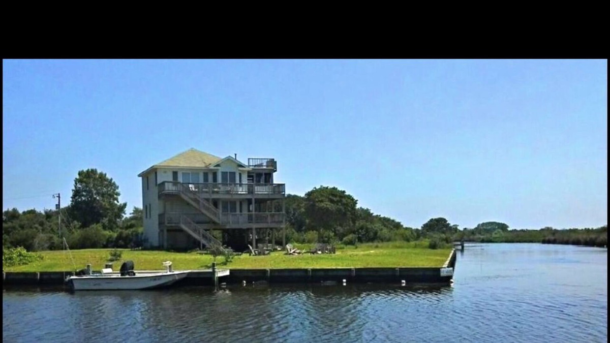 Carova Beach Cottage | Beautiful Canal front home in 4x4 area beach parking passes and linens included!