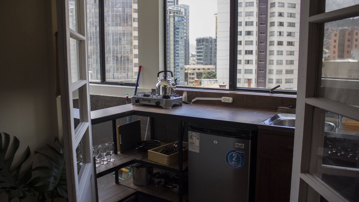 Downtown La Paz Apartment | Bedroom + living room. Central heating, fireplace and garden