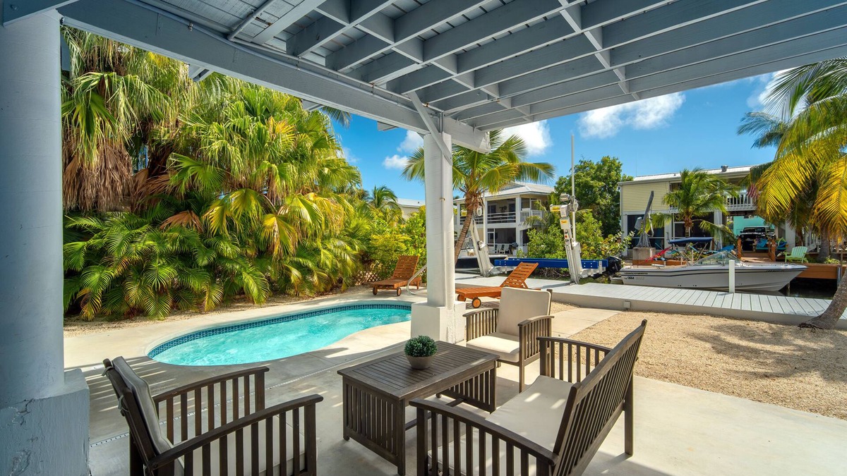 Breezeswept Beach Estates House | Cayman Retreat | Cozy coastal pool home with boating on Ramrod Key