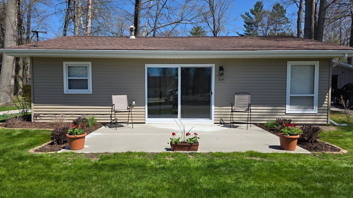 Prudenville Cottage | Centrally located, four season retreat w/firepit and lakeview.