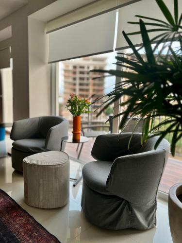 North Hotel Zone Apartment | Chic 1BR 1BA Zoho Skies condo with rooftop pool stunning views