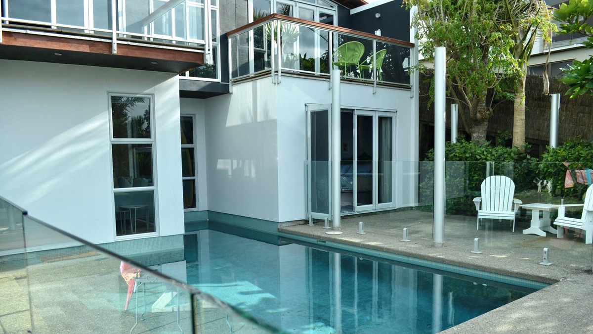 Stanmore Bay Apartment | Cool apartment surrounded by a pool & lovely lush tropical garden.