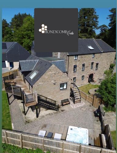 Douglas and Angus Apartment | CORN FLOUR LODGE at PITKERRO MILL, 3 double bedrooms with TVs, 1 en-suite, 2 further bathrooms, fully equipped kitchen, large family dining area, FREE parking and WiFi, HOT TUB, private garden, short mid and longterm stays available with HONEYCOMB HOSTS