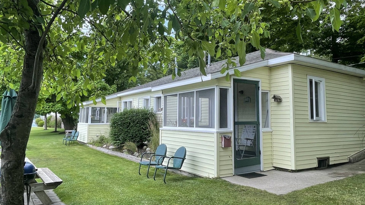 Ludington Cottage | Cottage 1 is a charming 2 bedroom only 25’ from its boat dock & Hamlin lake.