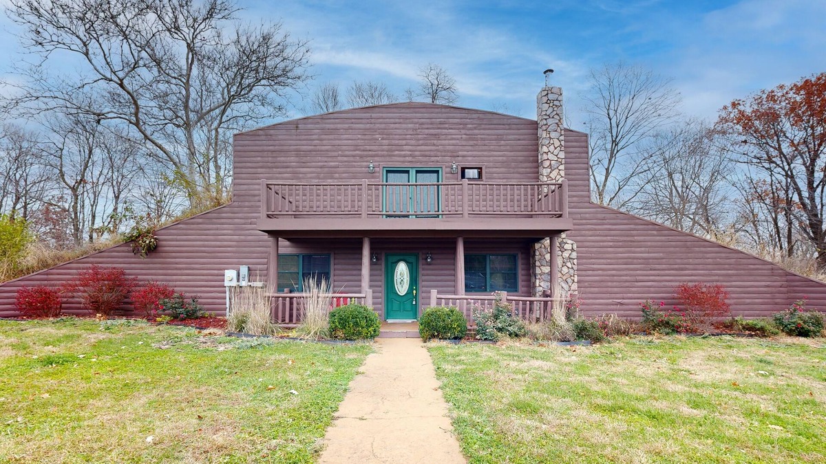 Banner House | Cozy Hobbit House inspired home with large balcony and front porch