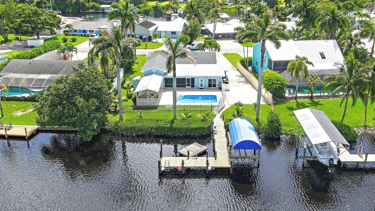 Palm City House | Deep water front home with private dock, pool, outdoor kitchen and pool table.