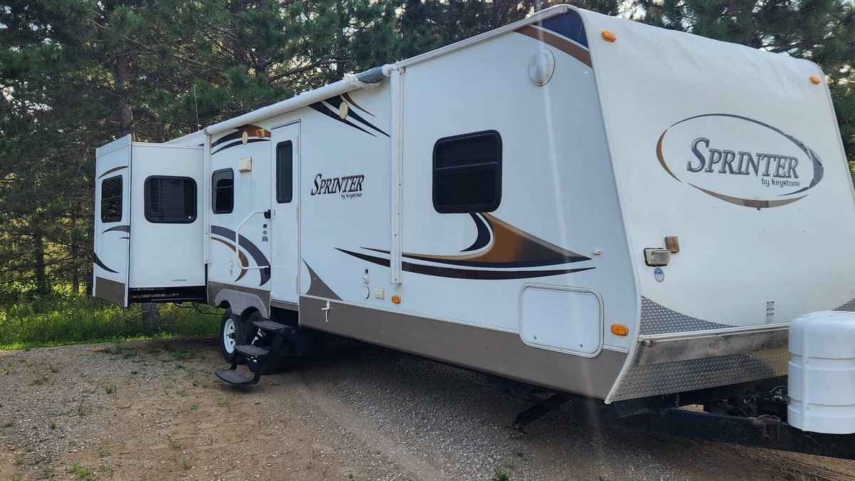 Nevis RV Rental | Deluxe Camper at a RV park