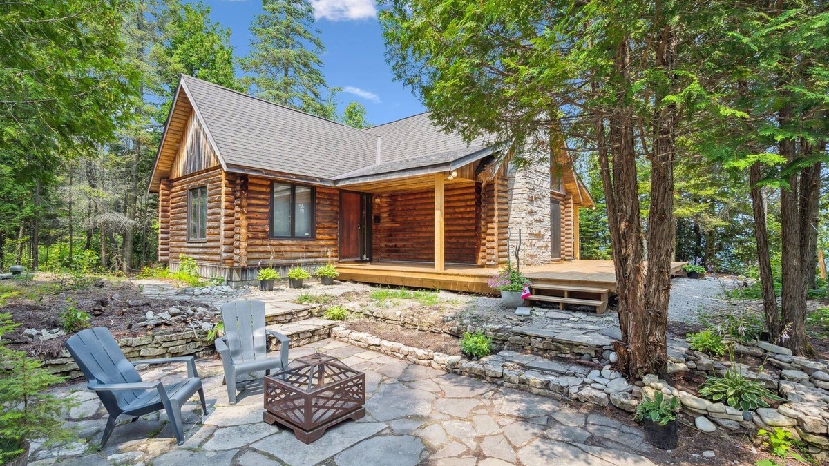 Lion's Head Cabin | Disconnect from it all at Stonewood, a cozy log chalet nestled in cedar forest on Georgian Bay. Enjoy a private shoreline, wraparound deck, wood stove, and access to kayaks, and trails. Peace, comfort, and adventure await in Cape Chin South.