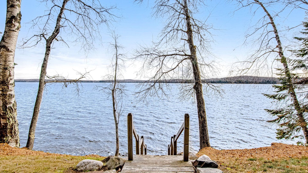 Presque Isle Cabin | Dog-friendly cabin with waterfront views, lake access, sandy beach, & rec room