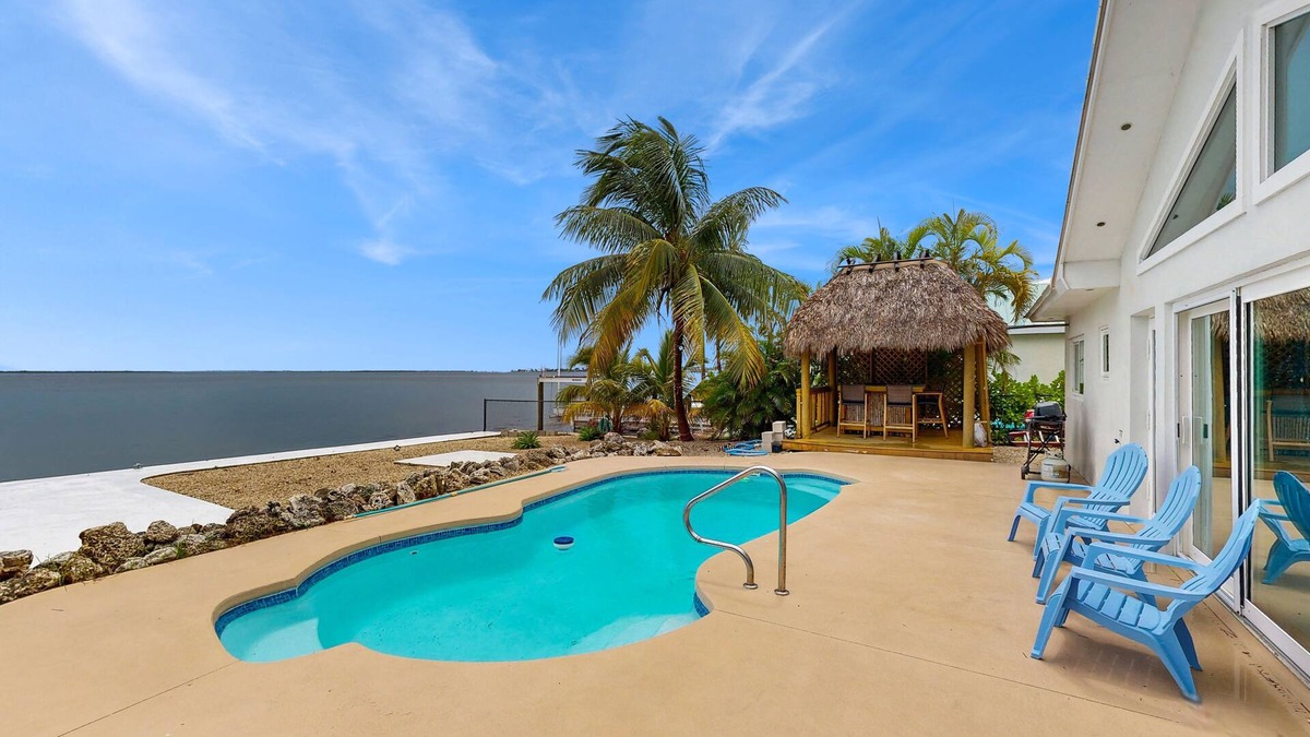 Tropical Bay Estates House | Dog-friendly home with waterfront views, a pool & Wifi