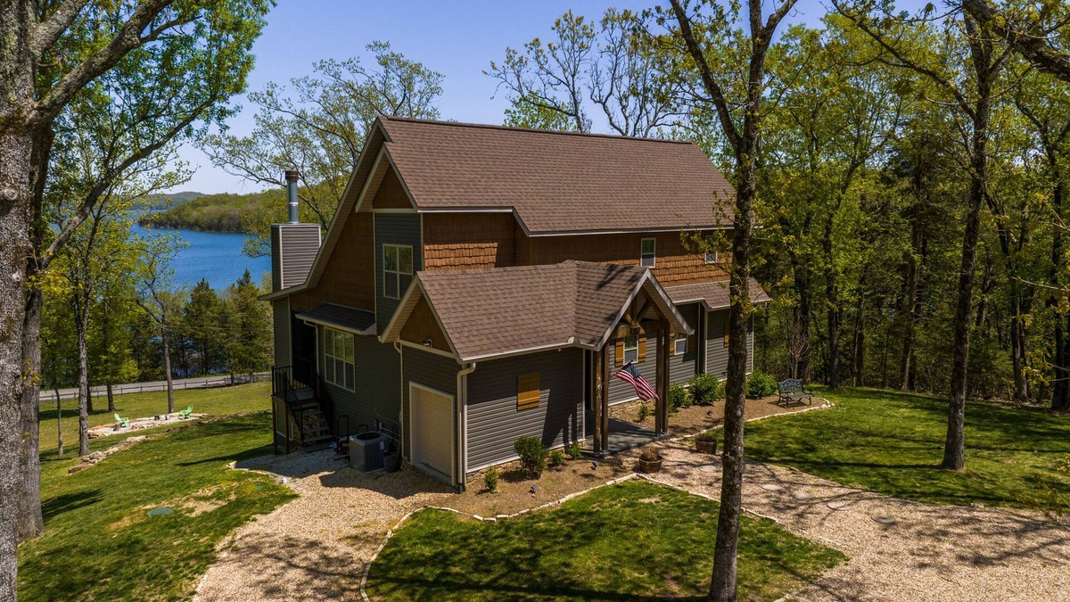Rogers House | Elegant lakefront home with a fireplace, screened patio & lovely views