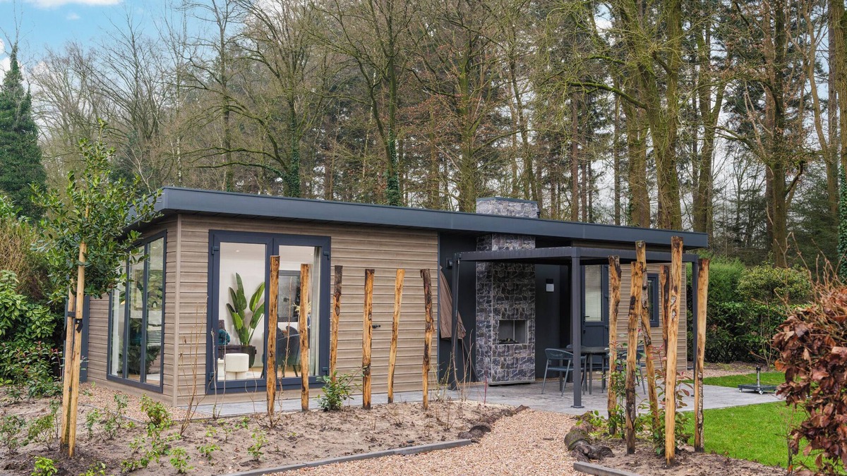 Lieren House | Enjoy a luxury holiday home in the wooded nature of the Veluwe, featuring modern amenities, air conditioning, and a stylish pergola with electric fireplace for optimal comfort.