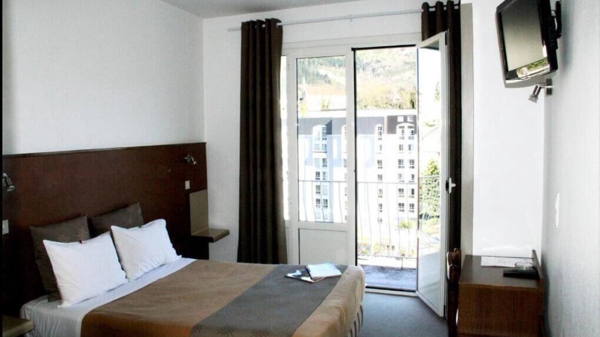Lourdes Hotel | Enjoy Homelike Comfort & Balcony Sights w/Modern Amenities in Lourdes