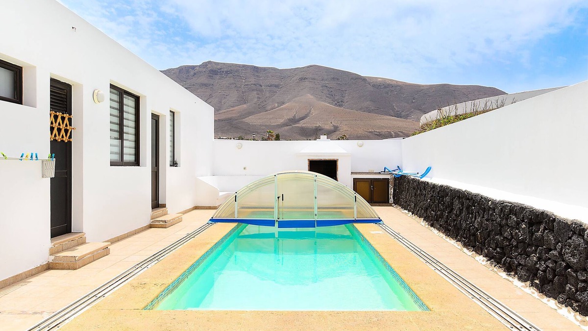 Urbanizacion Famara Apartment | Famara Beach Apartment on the Shore with Shared Pool, Terrace, Ocean/Mountain Views & Wi-Fi