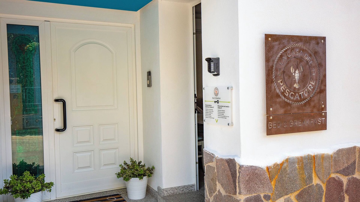Cala Gonone Bed & Breakfast | Family room with mountain view terrace and window overlooking the harbor.