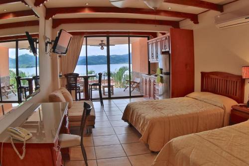 Playa Flamingo Apartment | Hotel room-style ocean-view unit in Flamingo with pool