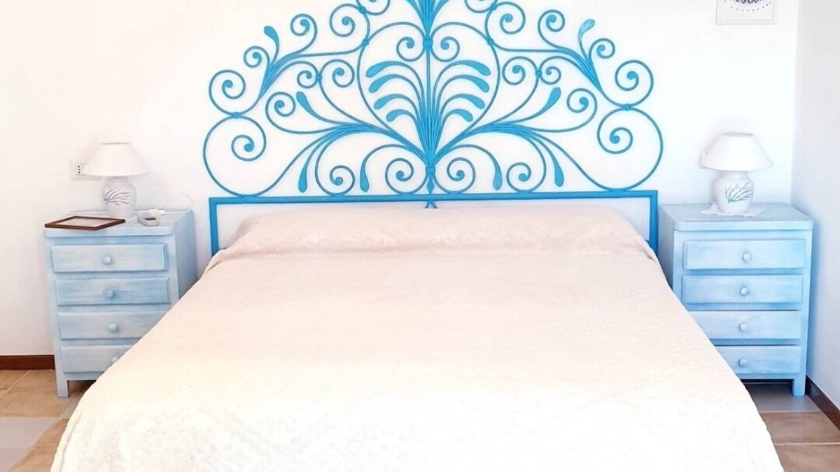 Baja Sardinia Apartment | Large and beautiful master bedroom with bathroom within walking distance of the sea.
