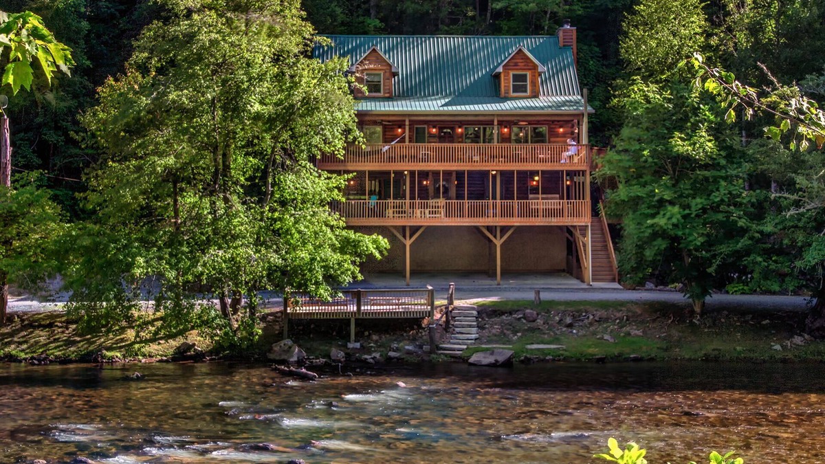 Sylva Cabin | Log cabin with large decks on the Bank of the Tuckasegee River.