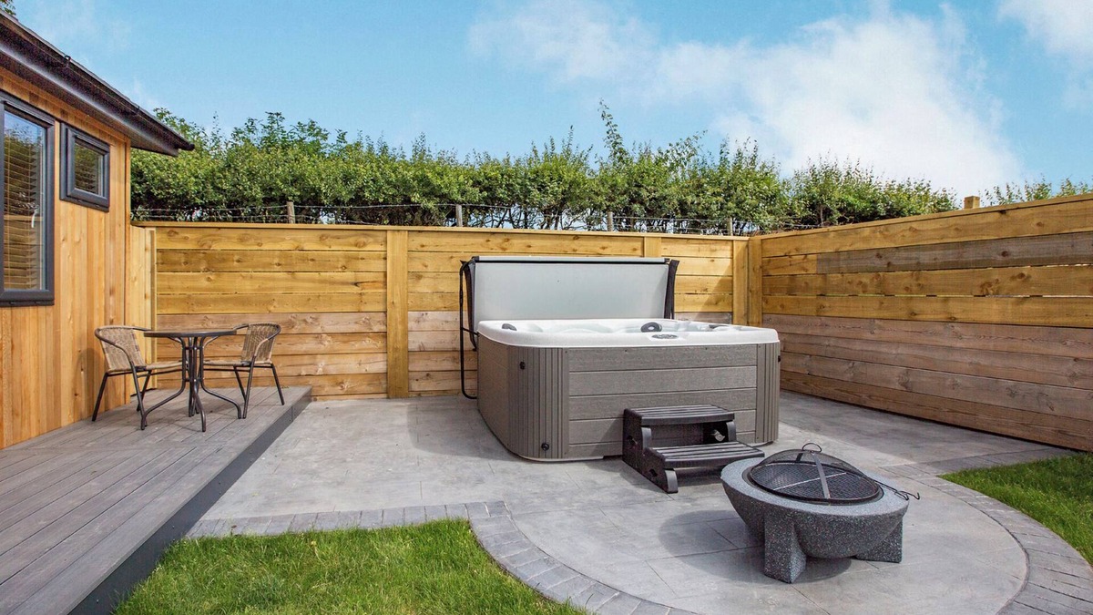 Middlezoy Ski Chalet | Luxurious lodge with vaulted ceilings and a welcoming feature fireplace.