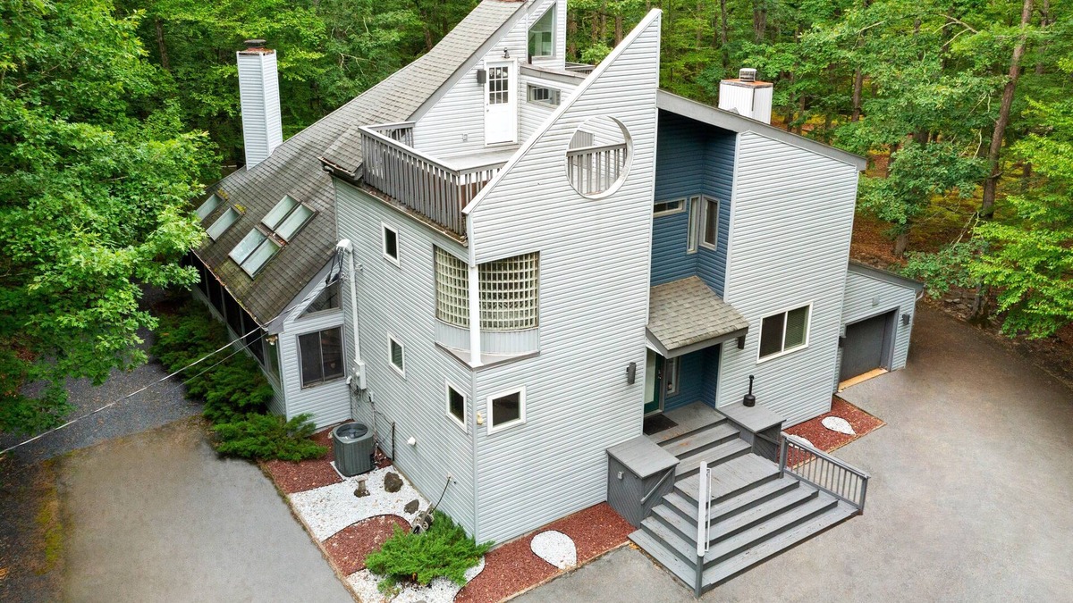Bushkill House | Modern Creek-front House with Volleyball court in the backyard.