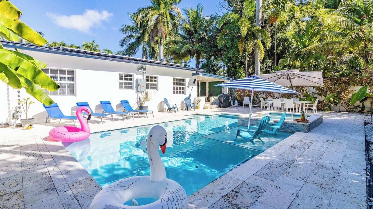 South Lake Villa | Modern Hollywood Beach villa with a private heated saltwater pool, hot tub, and spacious family-friendly layout. Just 1 mile from the ocean & Broadwalk, featuring a full kitchen, open living areas, and tropical outdoor lounge spaces.