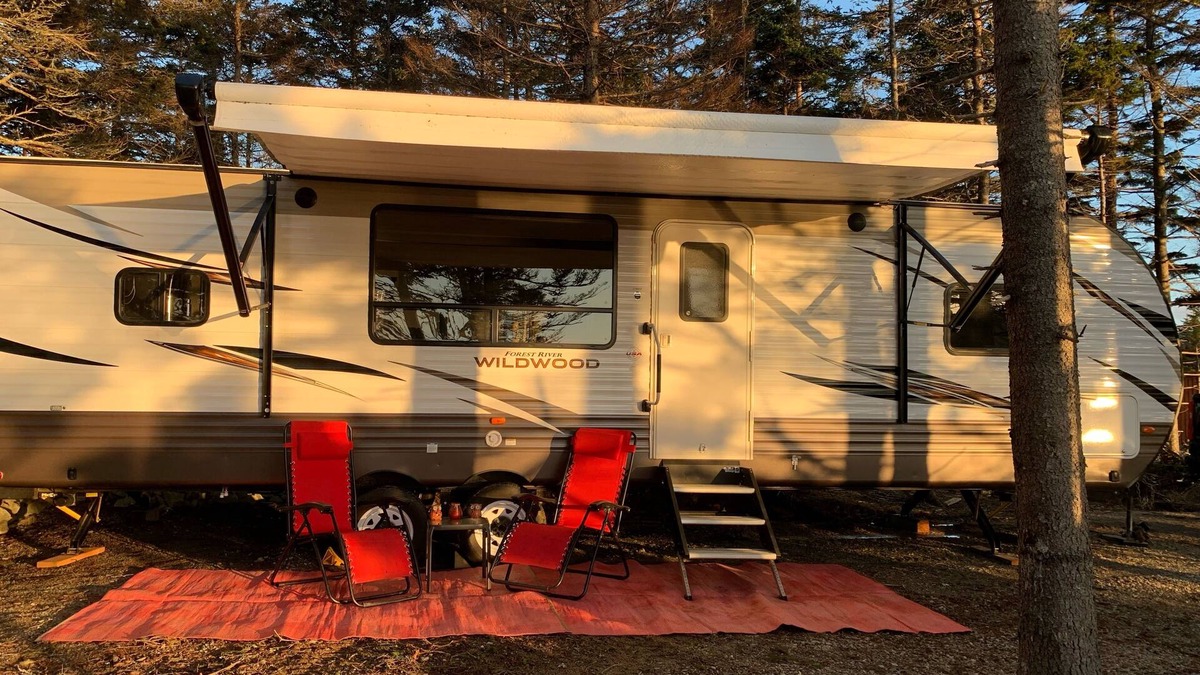 Clare House | Modern RV camper with all the perks nNestled in tree at lake edge