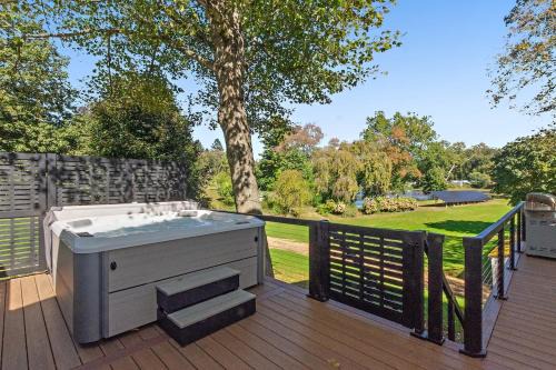 Versailles Villa | Modern Waterfront Retreat with Hot Tub & Pond Views