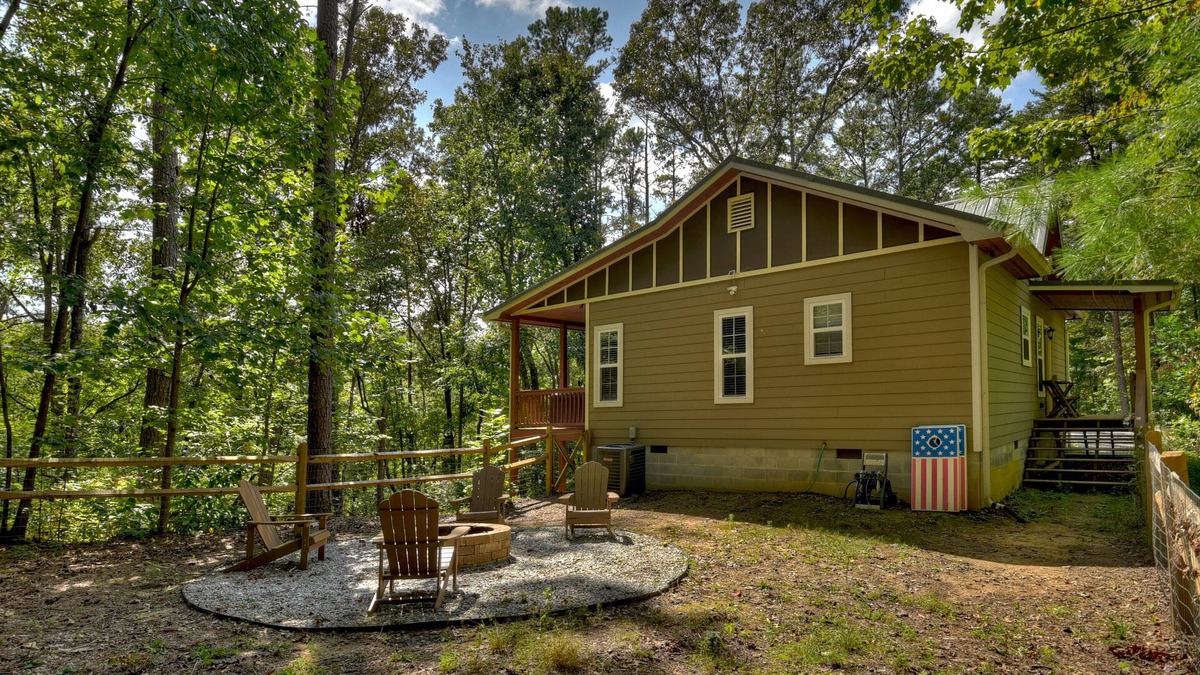 Ellijay Cabin | Mountain Livin' beckons with pet-friendly charm, complete with a fenced yard, soothing hot tub, crackling firepit, and reliable WiFi