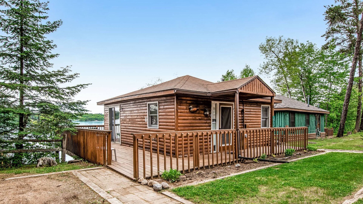 Arbor Vitae Cabin | New listing! Lakefront cabin with dock, over-water deck, year-round views!