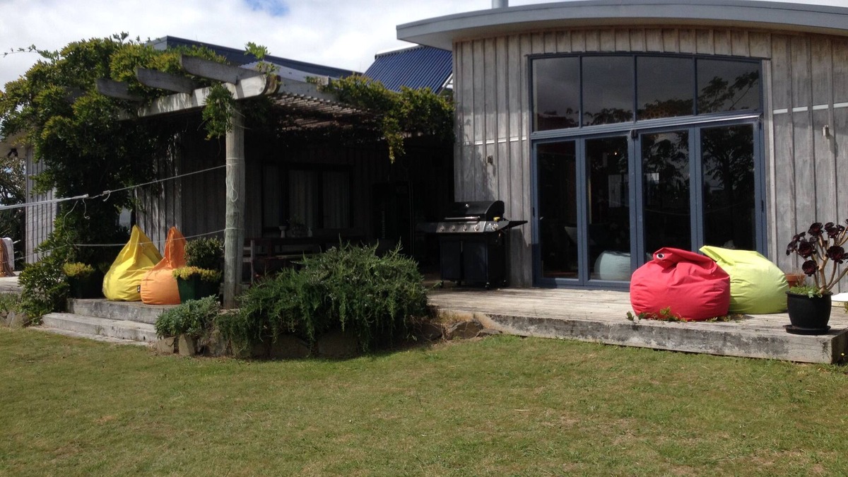 Raglan House | Okete Landing - Lifestyle retreat on Raglan harbour with grass tennis court.
