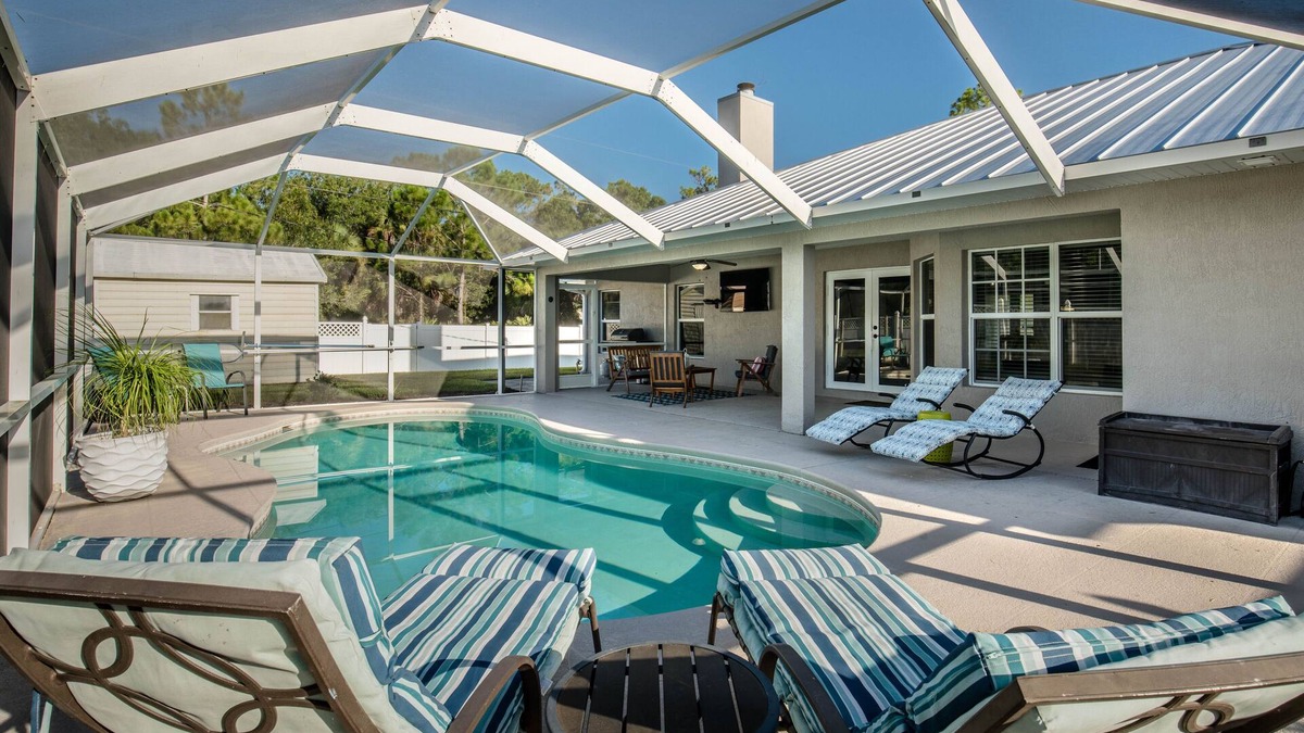 Vero Lake Estates House | 🍹🌞 Palm Paradise! Heated Pool, Lanai with TV, Grill, & Fenced Yard!