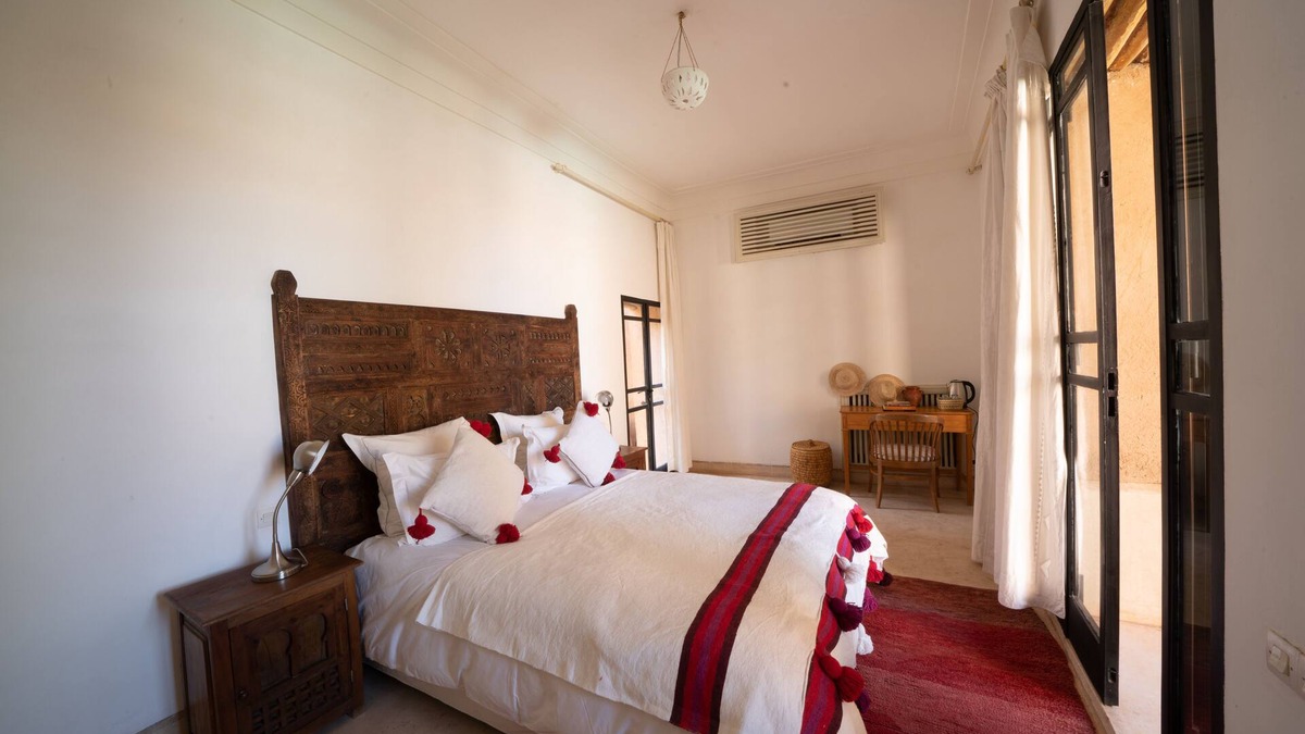 Oumnass House | Pool-view romantic bedroom