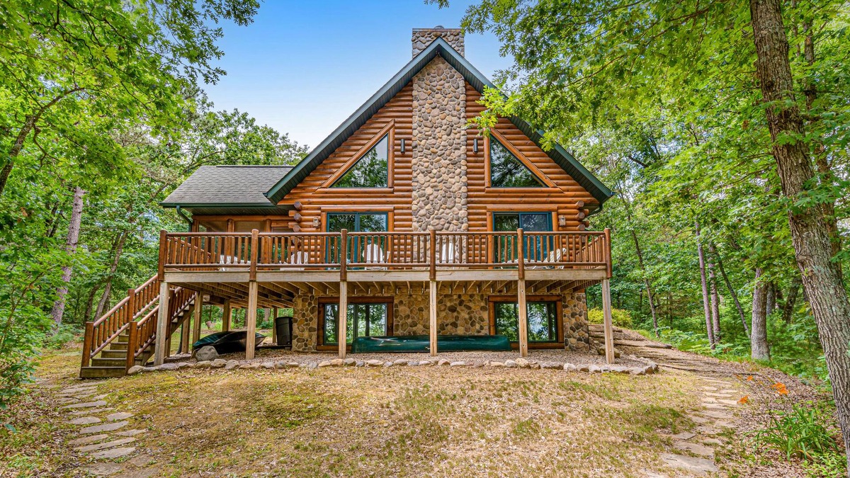 Lyndon Station Cabin | Riverfront cabin with a dock, kayaks and a canoe - firepit and water views