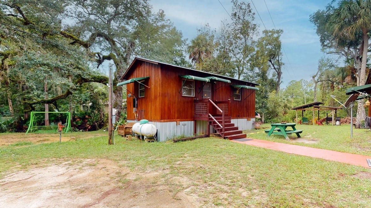 Bronson Cabin | Rustic riverfront cabin with views, firepit, grill, canoe, kitchen, & W/D