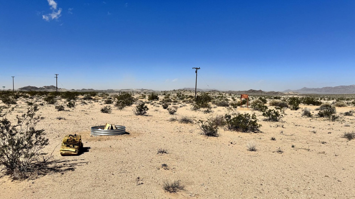 Wonder Valley RV Rental | RV space with fire pit under the stars