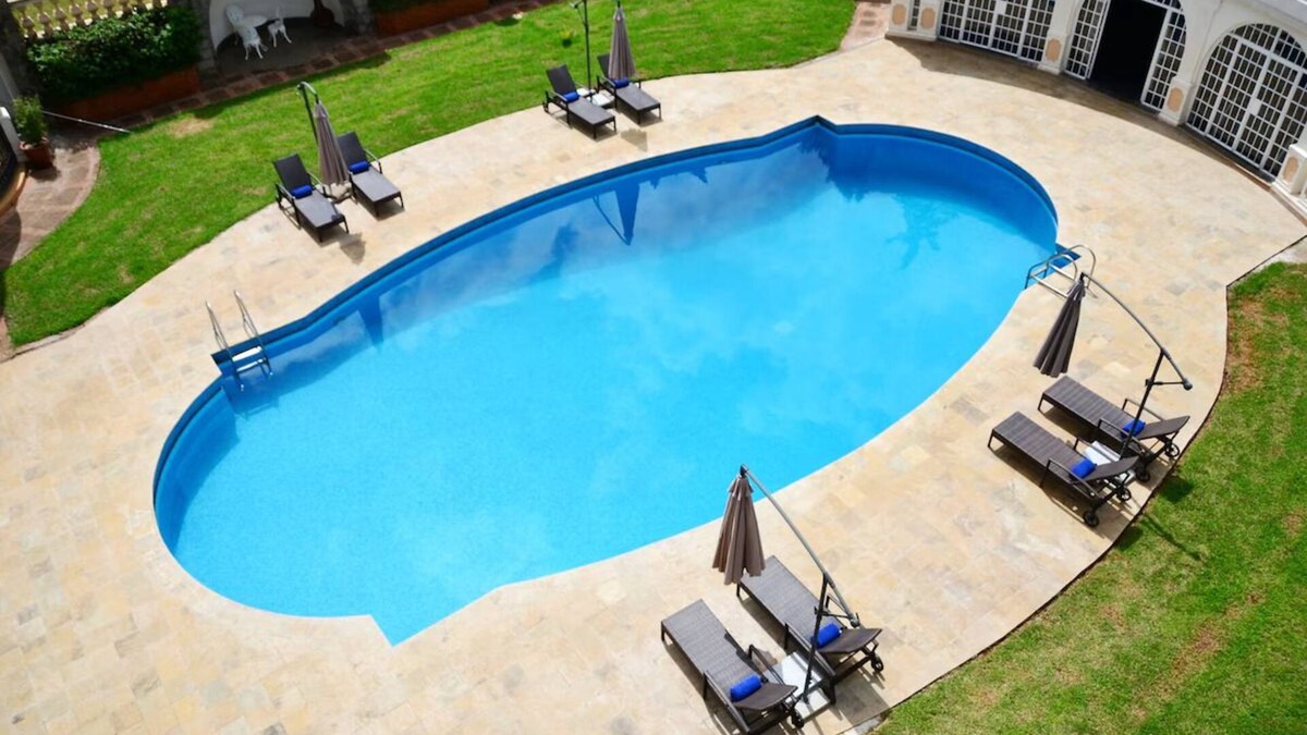 Limuru Hotel | Scenic Escape: Elegant Room Overlooking Lush Grounds