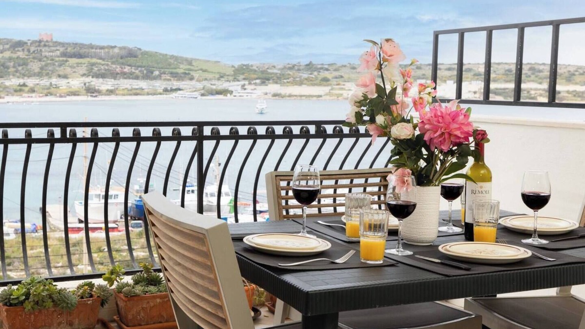 Għadira Apartment | Seafront apartment just steps from Mellieħa Bay, with stunning views of the bay and Red Tower. Enjoy spectacular sunsets, walk to nearby restaurants and amenities, and catch the bus right outside.