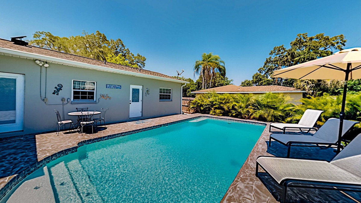 Harbor Bluffs House | Single-story home with outdoor dining, firepit, home office & laundry room