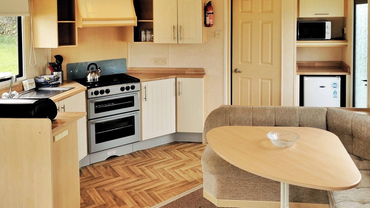 Llanllwchaiarn House | Spacious and comfortable 12ft-wide caravan with one double and two twin.