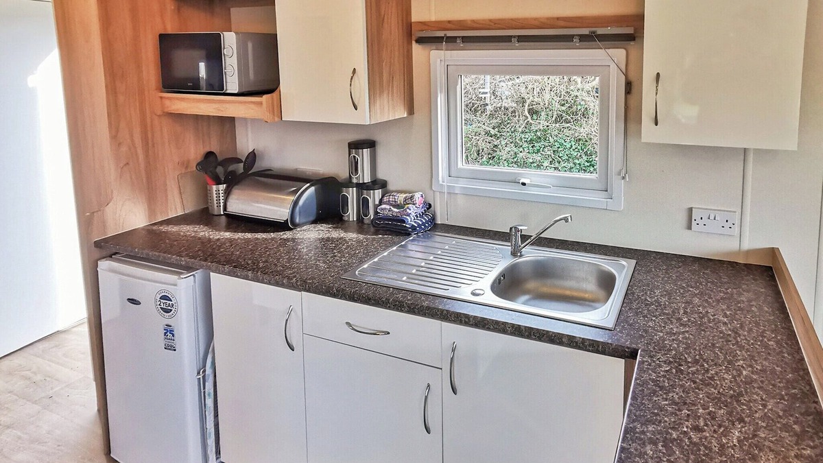 Llanllwchaiarn House | Spacious and well presented, 12-ft wide caravan with one double and one twin bedroom.