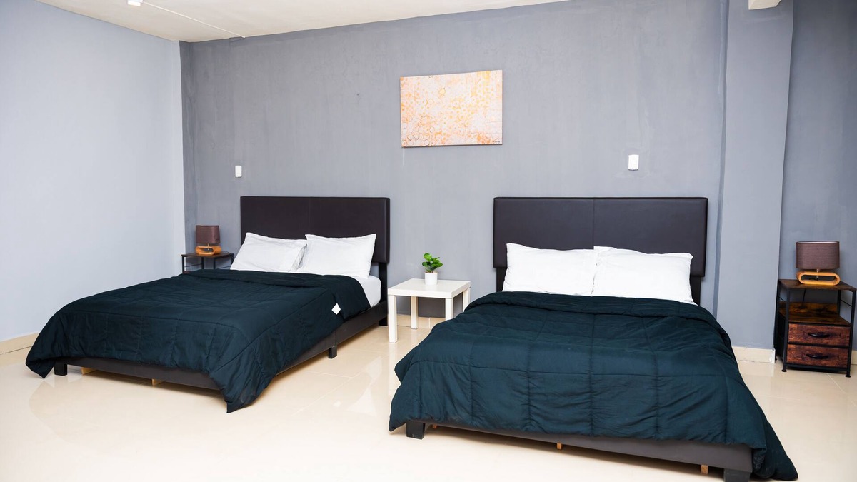 Margibi County Apartment | Studio suite with Two Queen Bed, Sofa and kitchen