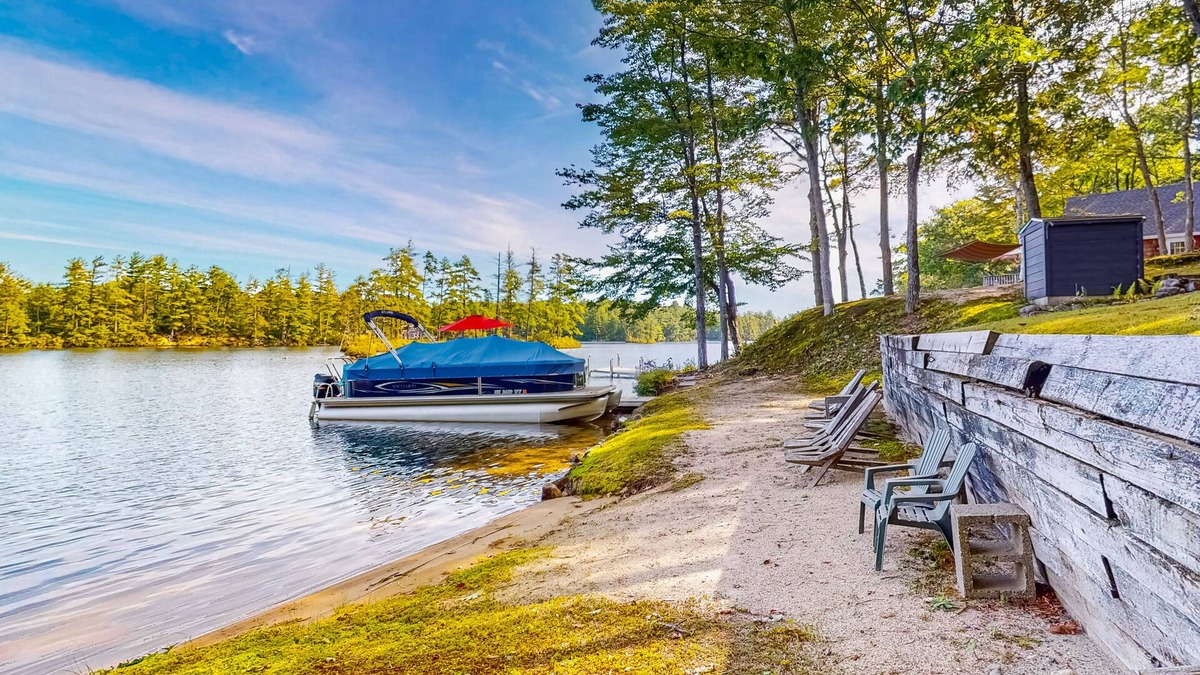 Pine River Pond House | Stunning lakefront home with private dock, deck, firepit, and lake view