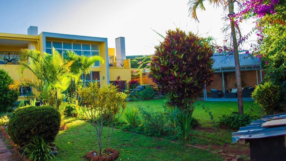 Ambohibao Villa | The white-orange bedroom with a pleasant view overlooking the lake
