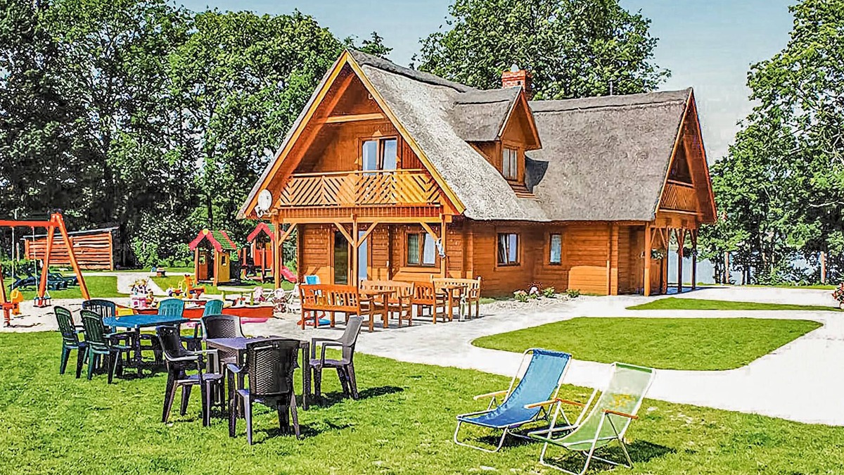 gmina Wolin House | This beautiful, well-maintained wooden house is located on a large, fenced lot.