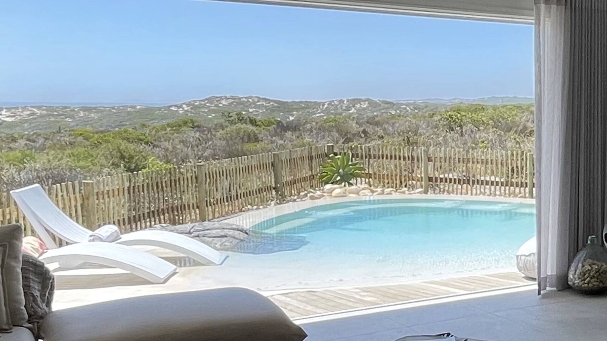 Grotto Bay House | Tranquil haven: home in nature's embrace, where ocean and dunes unite.